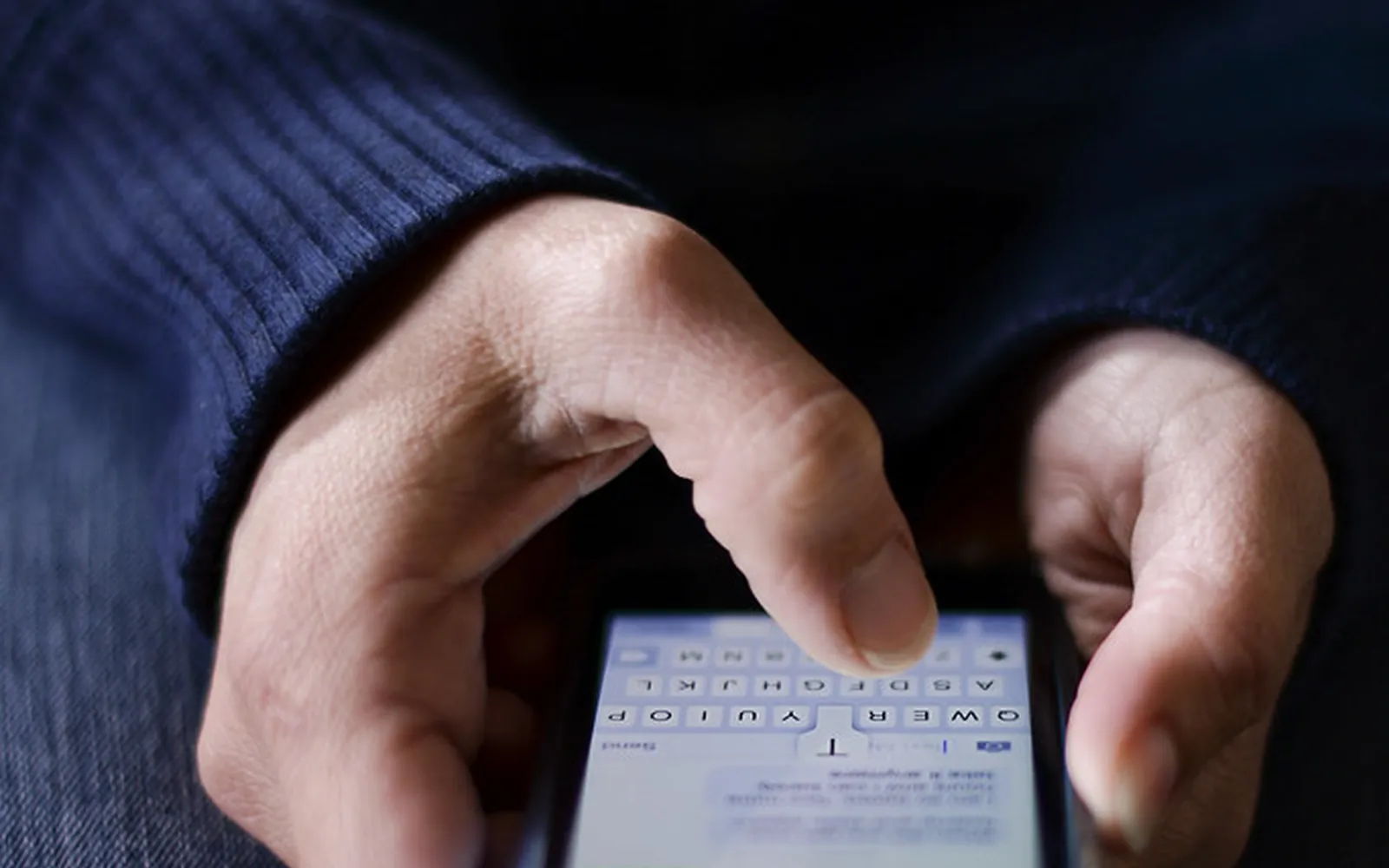 Hands holding a smartphone and typing a message